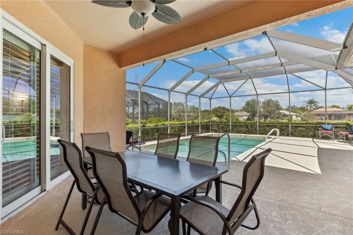View of patio featuring an outdoor pool, a lanai, and a ceiling fan