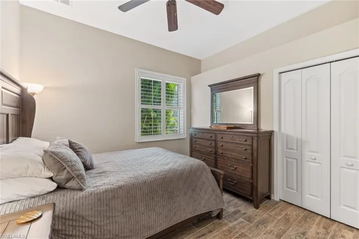 Bedroom featuring a closet, wood finished floors, and a ceiling fan