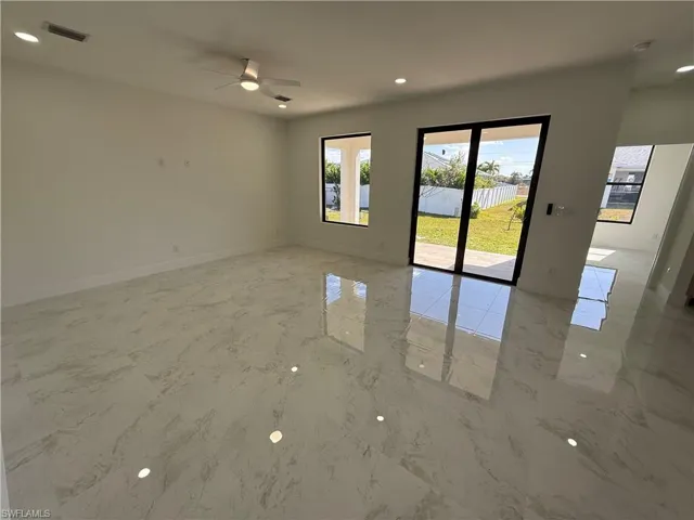 Spare room featuring recessed lighting, a ceiling fan, and light marble finish flooring