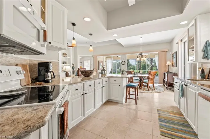15437 Puffin Drive Bonita Springs FL 34135 - Pendant lit casual dining area.