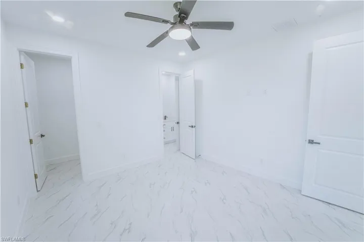 Tiled bedroom with ceiling fan