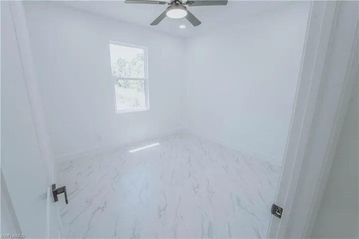 Spare room with ceiling fan