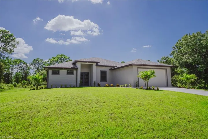 Prairie-style house with a garage and a front yard