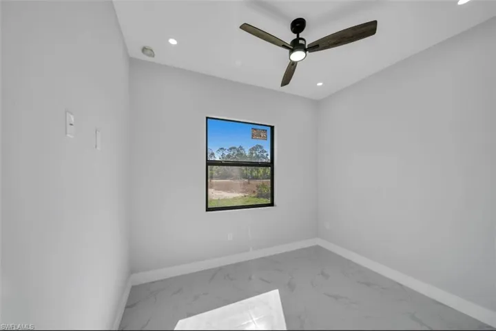 Unfurnished room with marble look tile flooring, recessed lighting, and a ceiling fan