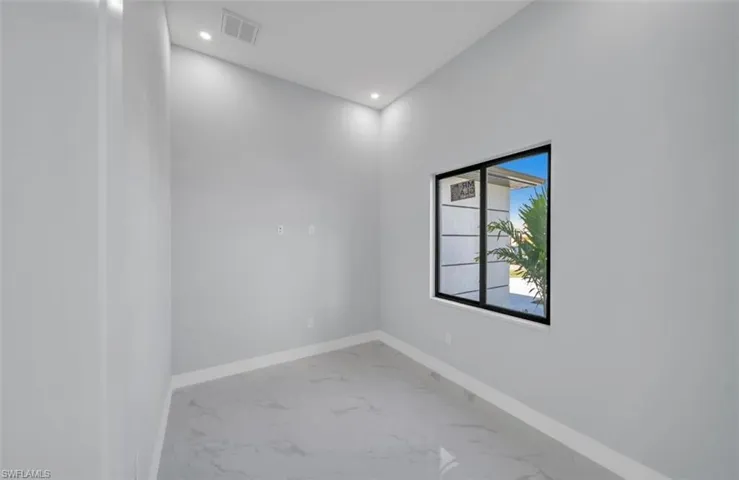 Spare room featuring recessed lighting and light marble finish floors