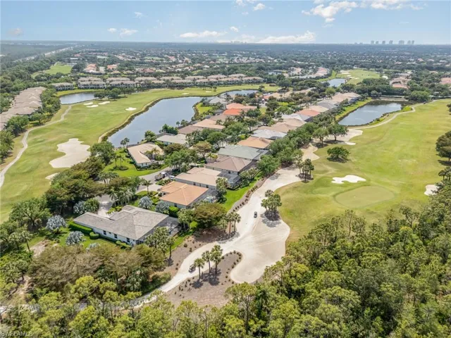 Drone / aerial view with golf course view, a water view, and a residential view