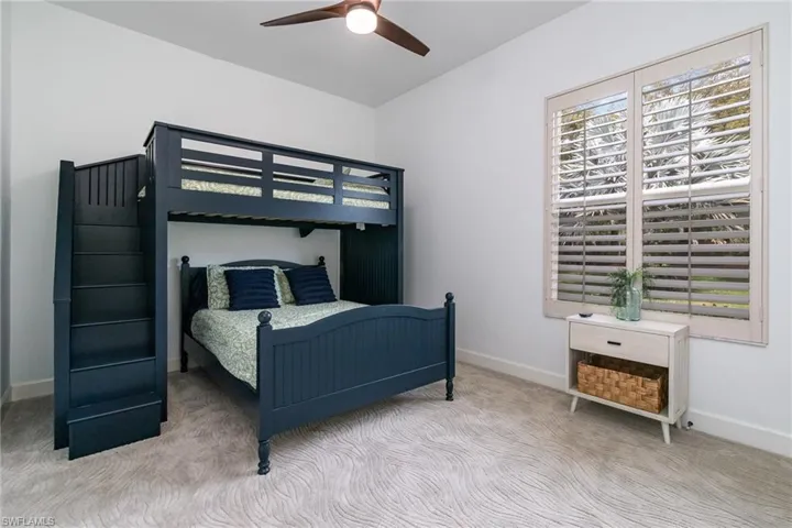 Bedroom featuring carpet flooring, multiple windows, and baseboards