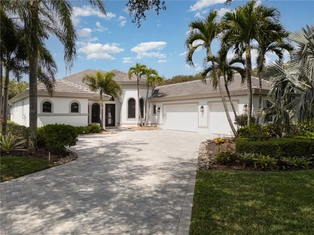 Mediterranean / spanish home featuring decorative driveway, a garage, and stucco siding