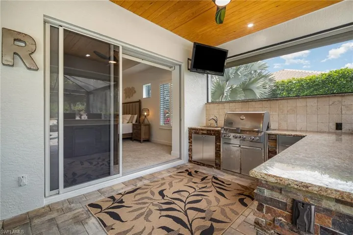 View of patio / terrace featuring a grill, ceiling fan, a sink, and area for grilling