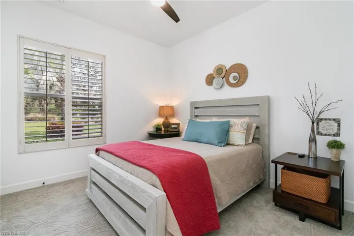 Bedroom featuring baseboards, carpet flooring, and a ceiling fan