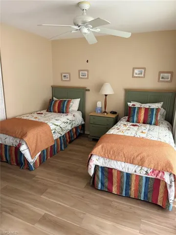 Bedroom with wood finished floors and ceiling fan