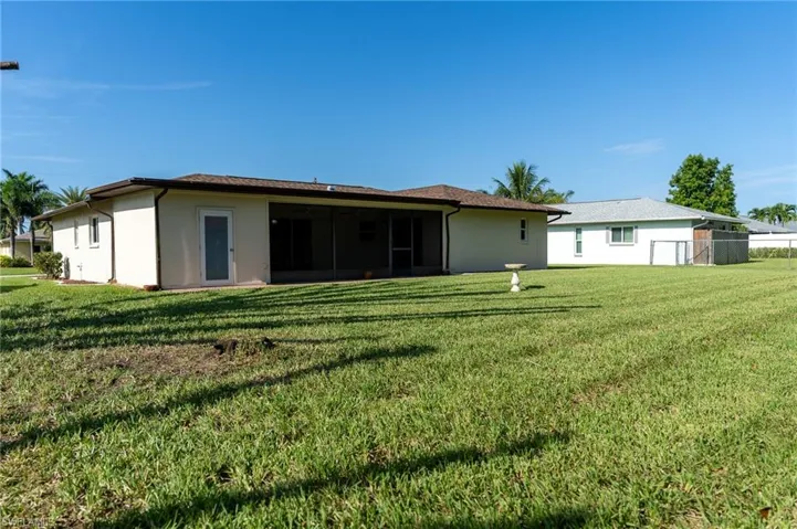 Ranch-style house featuring a garage, stucco siding, a shingled roof, and driveway