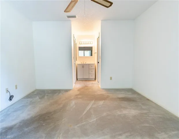 Unfurnished sunroom with ceiling fan