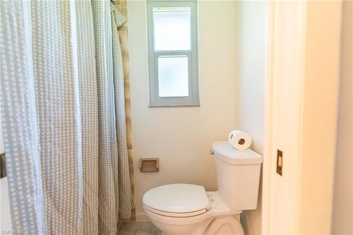 Primary Bathroom featuring vanity, a closet, and a ceiling fan