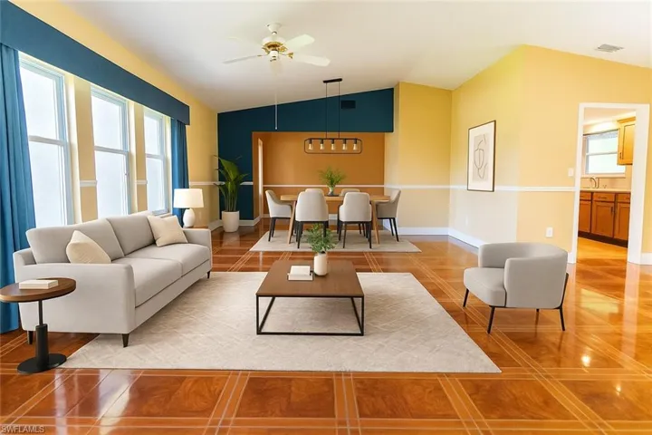 Virtually Staged Living area featuring plenty of natural light, vaulted ceiling, light tile patterned floors, and a ceiling fan