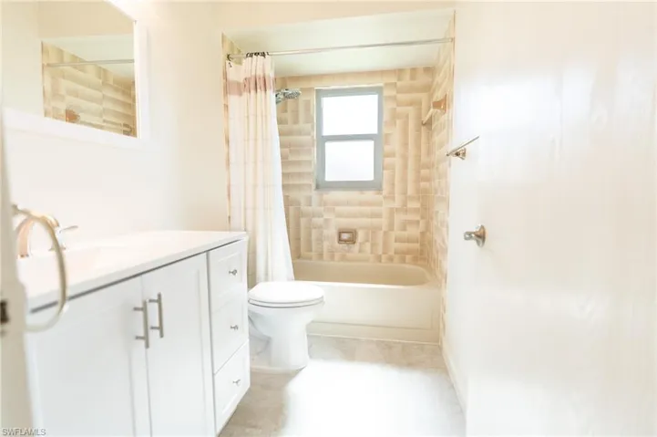 Bedroom featuring multiple closets, carpet flooring, and a ceiling fan