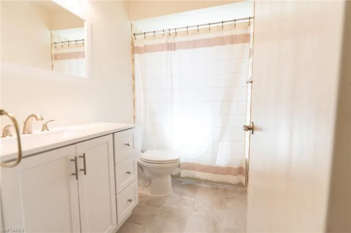Unfurnished bedroom featuring two closets, carpet floors, and ceiling fan