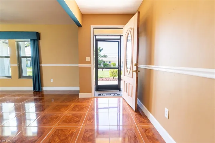 Entrance foyer with tile patterned flooring and baseboards
