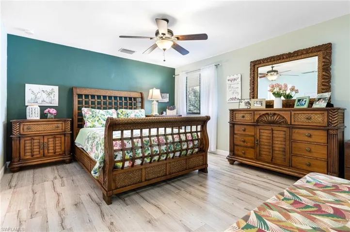 Bedroom with ceiling fan and hardwood / wood-style floors
