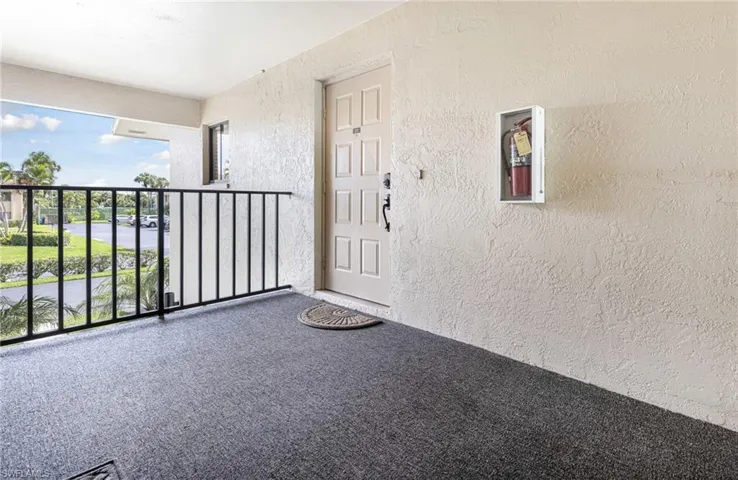 View of exterior entry with a balcony