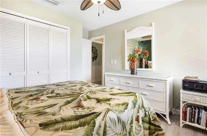 Bedroom featuring light hardwood / wood-style floors, a closet, and ceiling fan