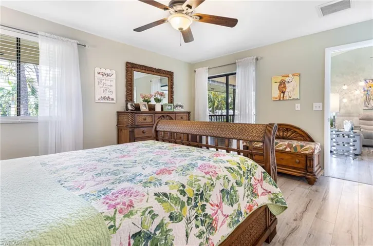 Bedroom with light hardwood / wood-style floors and ceiling fan
