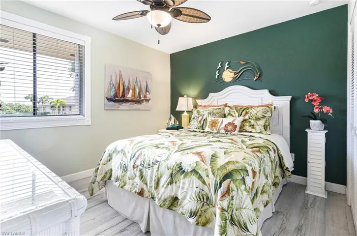 Bedroom with ceiling fan and hardwood / wood-style floors