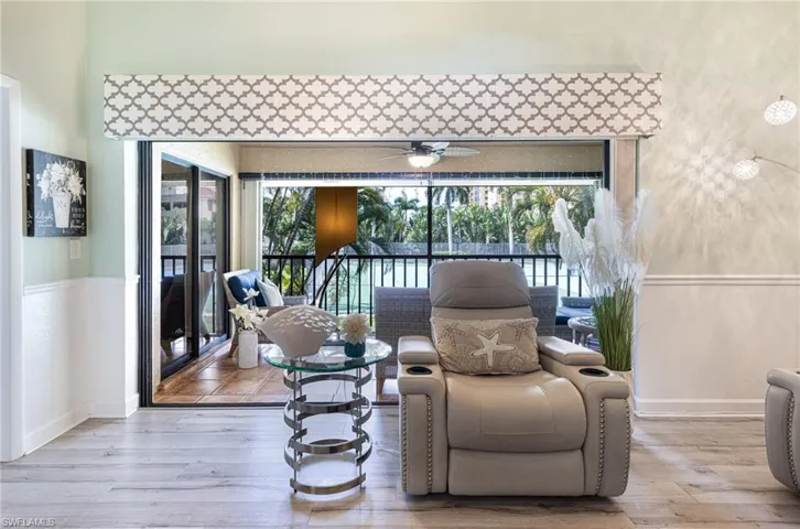 Living area featuring a wealth of natural light, hardwood / wood-style flooring, and ceiling fan