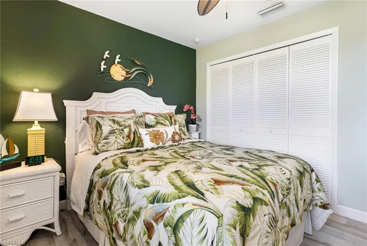 Bedroom featuring ceiling fan, hardwood / wood-style flooring, and a closet