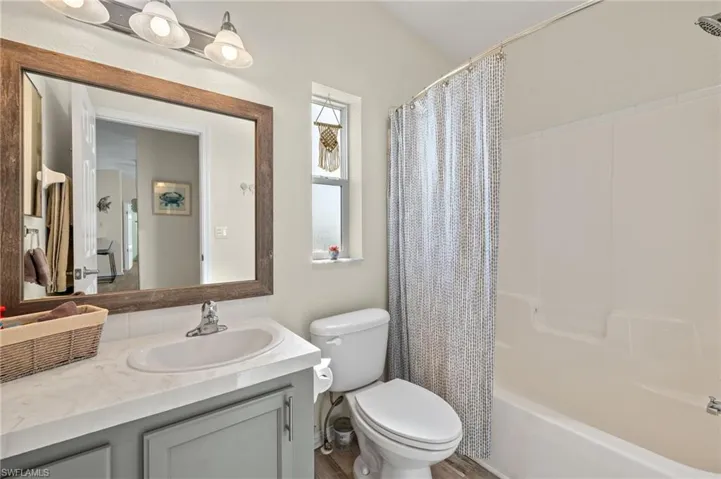 Full bathroom featuring oversized vanity, toilet, and shower / tub combo