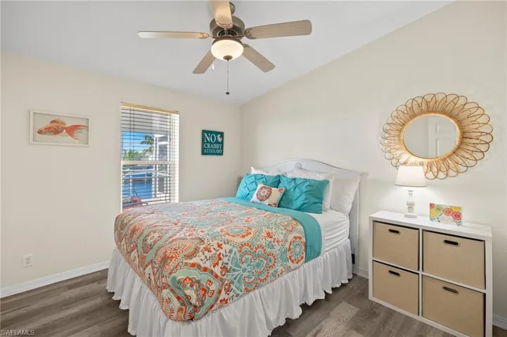 Bedroom with ceiling fan and dark wood-type flooring