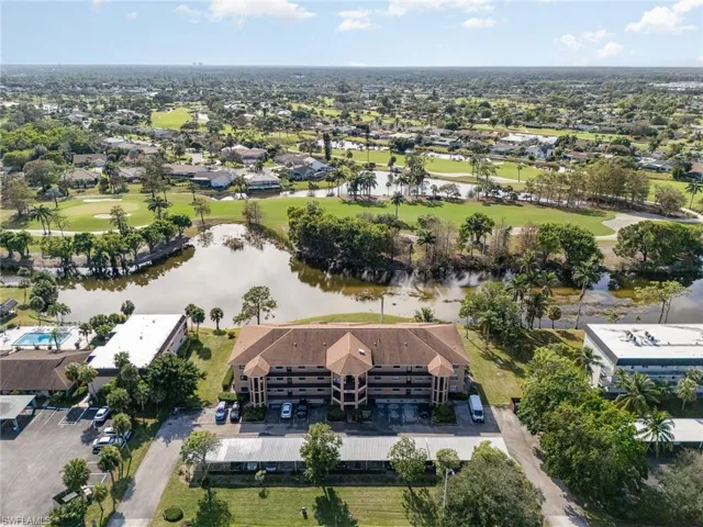 Birds eye view of property with a water view
