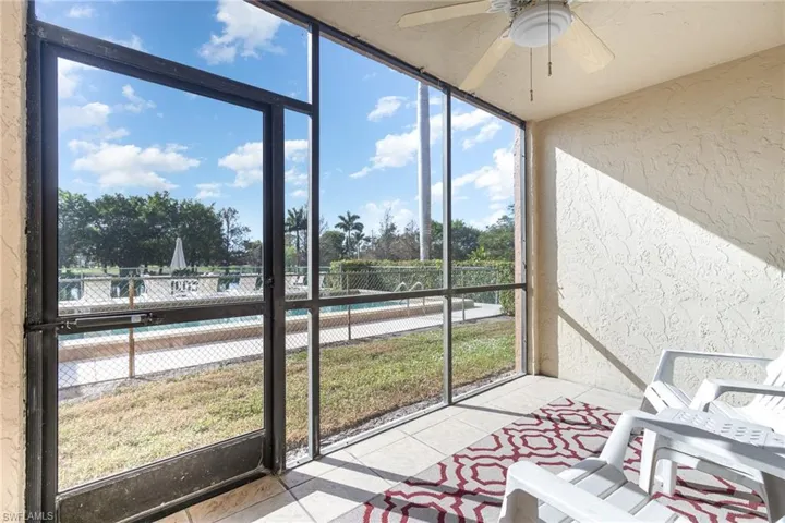 Fully screened-in lanai/patio with gorgeous view of pool, golf course and lush landscape.