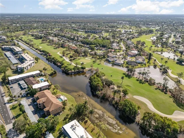 Birds eye view of property with a water view
