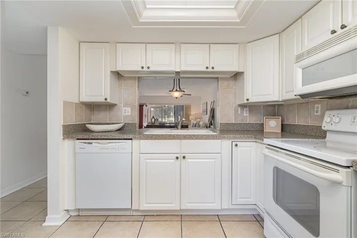 Light, neutral kitchen with white cabinetry.