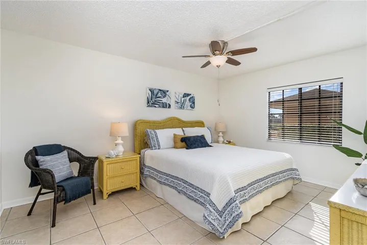 Primary Bedroom with ceiling fan and coastal decor.