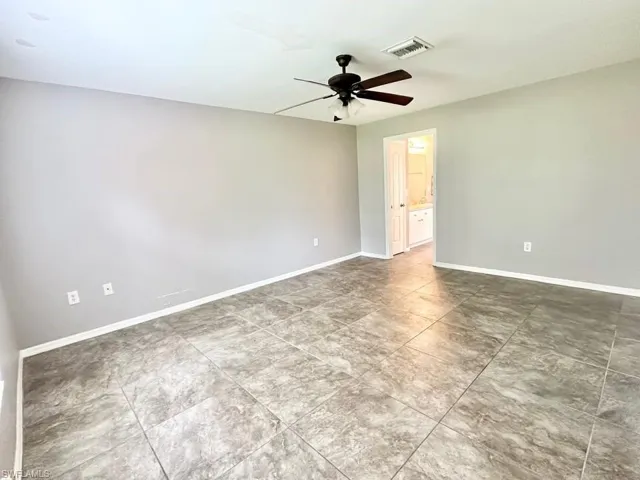Empty room with baseboards and ceiling fan