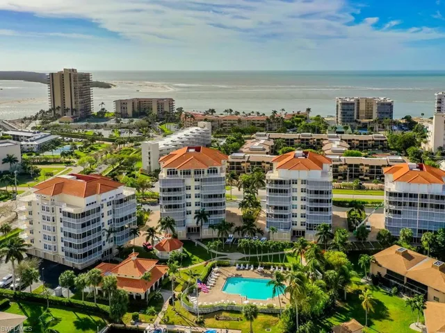 Birds eye view of property with a water view