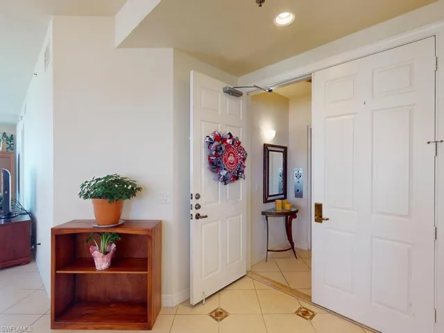 Entryway with light tile patterned floors