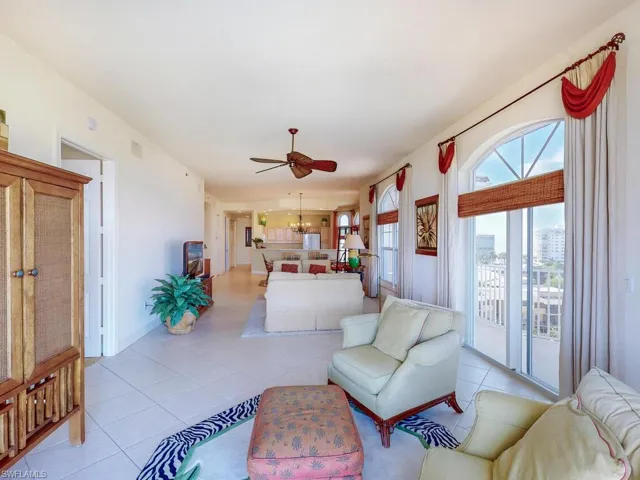 Tiled bedroom with ceiling fan and access to exterior