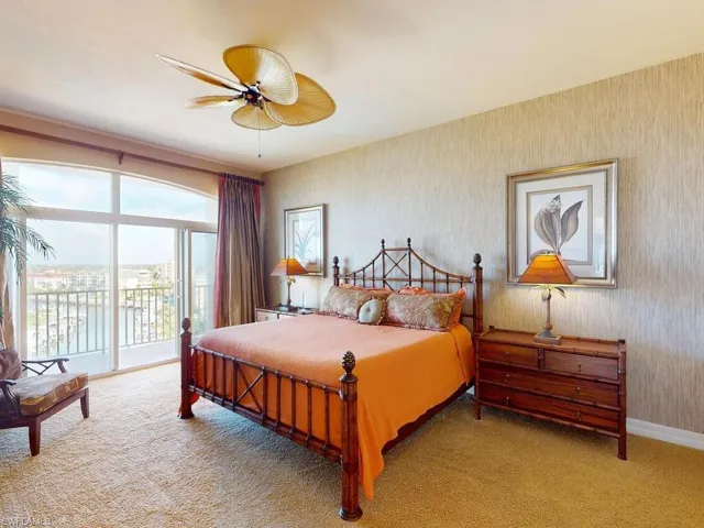 Bedroom with access to exterior, light carpet, and ceiling fan