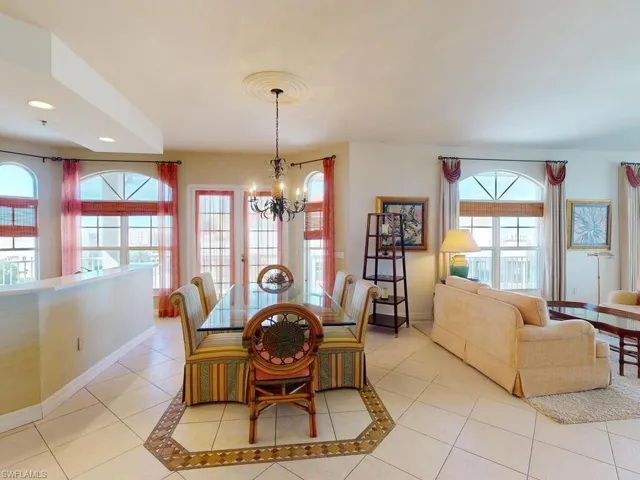 Tiled dining area featuring an inviting chandelier