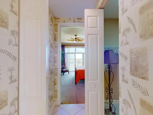 Corridor featuring light colored carpet