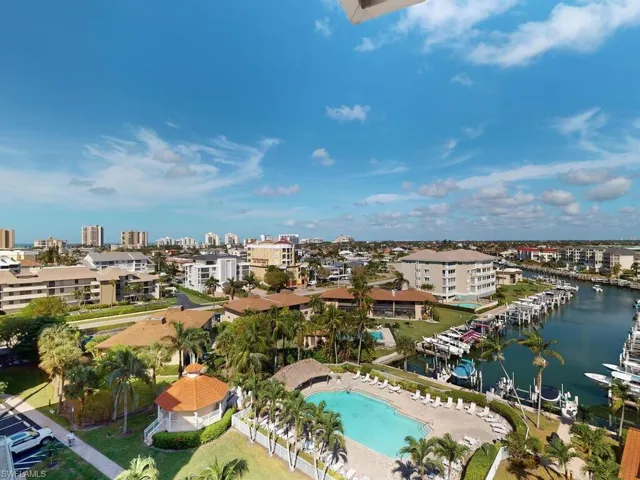 Birds eye view of property with a water view