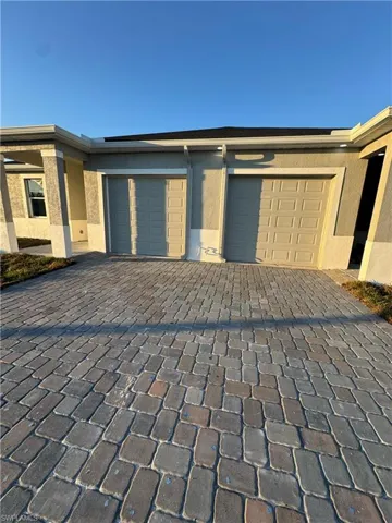 Garage featuring decorative driveway