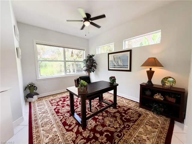 Home office featuring light tile patterned floors and a ceiling fan
