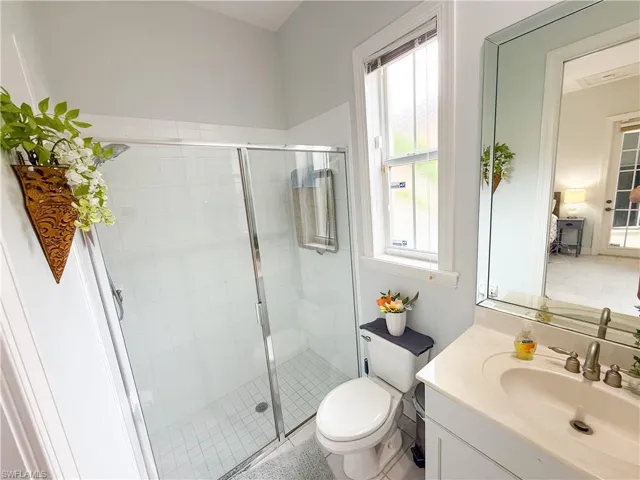 Full bathroom featuring vanity and a shower stall