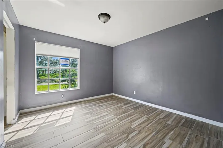Empty room with wood tiled floors and baseboards