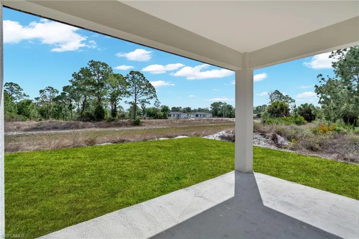 View of green lawn featuring a patio area