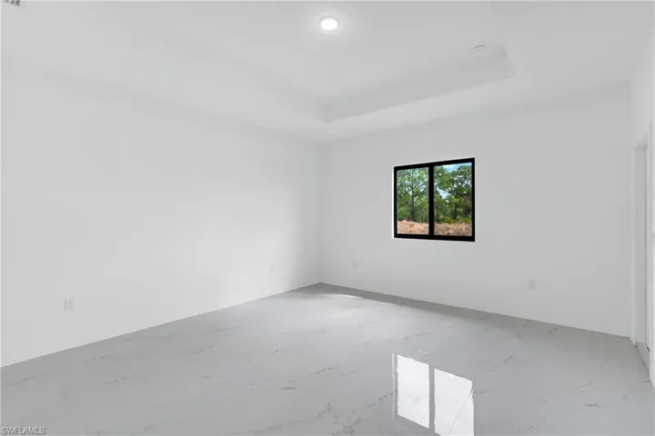 Unfurnished room featuring light marble finish floors